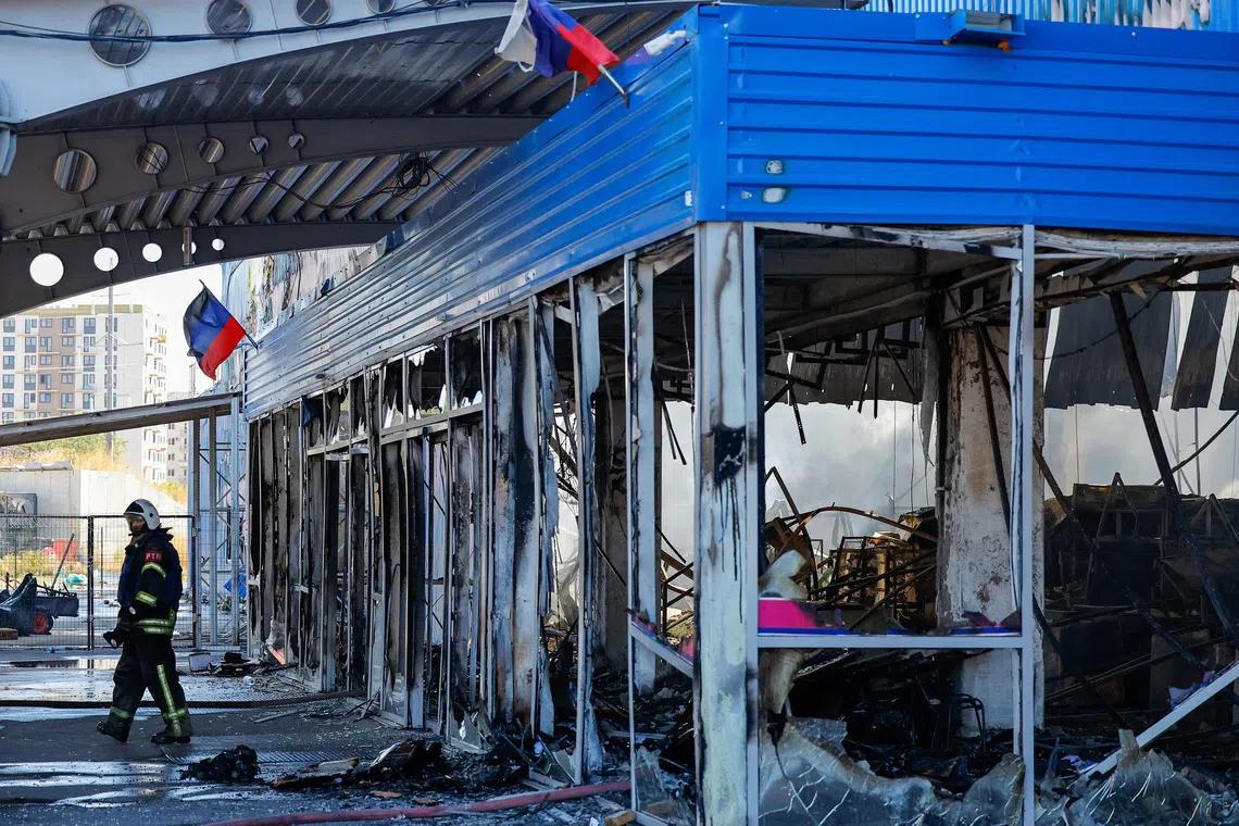 A firefighter walks out of the burnt-out shopping mall Galaktika (Galaxy) following an overnight attack, what Russian-installed authorities called a Ukrainian drone strike, in the course of the Russia-Ukraine conflict in Mariupol in the Donetsk region, a Russian-controlled area of Ukraine, September 7, 2026. REUTERS/Alexander Ermochenko