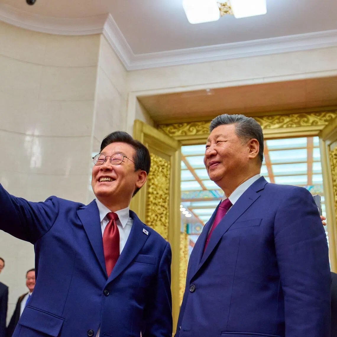 South Korean President Lee Jae Myung (left) taking a selfie with Chinese President Xi Jinping in Beijing on Jan 5, using a phone gifted to him by Mr Xi during their first summit in November 2025.