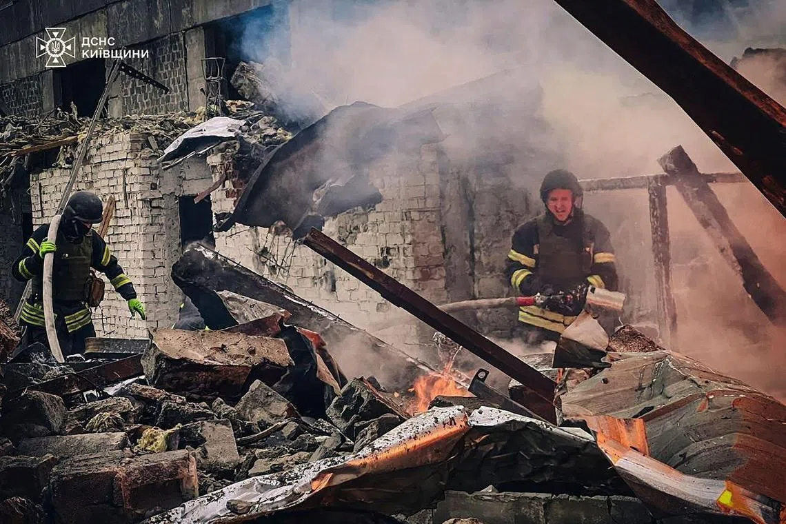 Firefighters extinguishing fire following a Russian strike in Brovary, near Kyiv.
