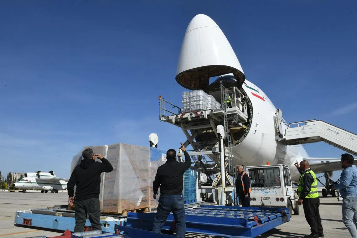 Employees unload humanitarian aid for Syria from an Iranian aircraft.
