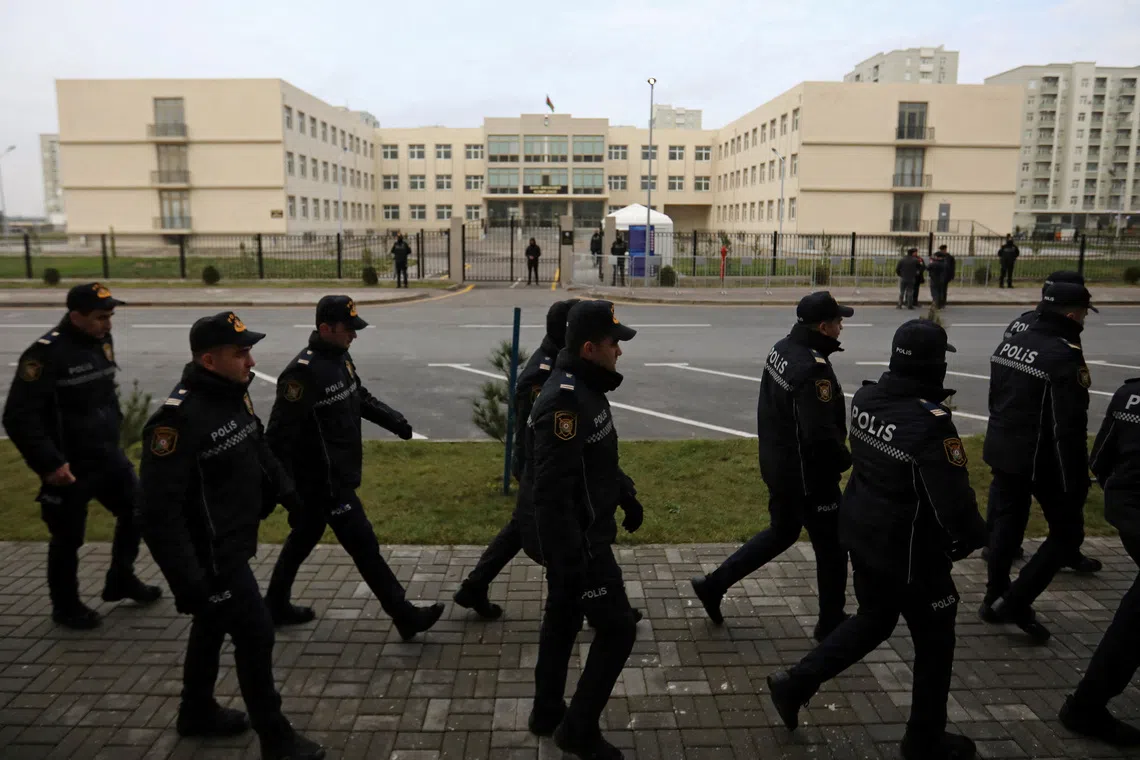 Police officers walk outside a courthouse on the day of the trial of former political figures and officials of the breakaway region of Nagorno-Karabakh, accused of various charges, including genocide and war crimes, in Baku, Azerbaijan January 17, 2025. REUTERS/Aziz Karimov