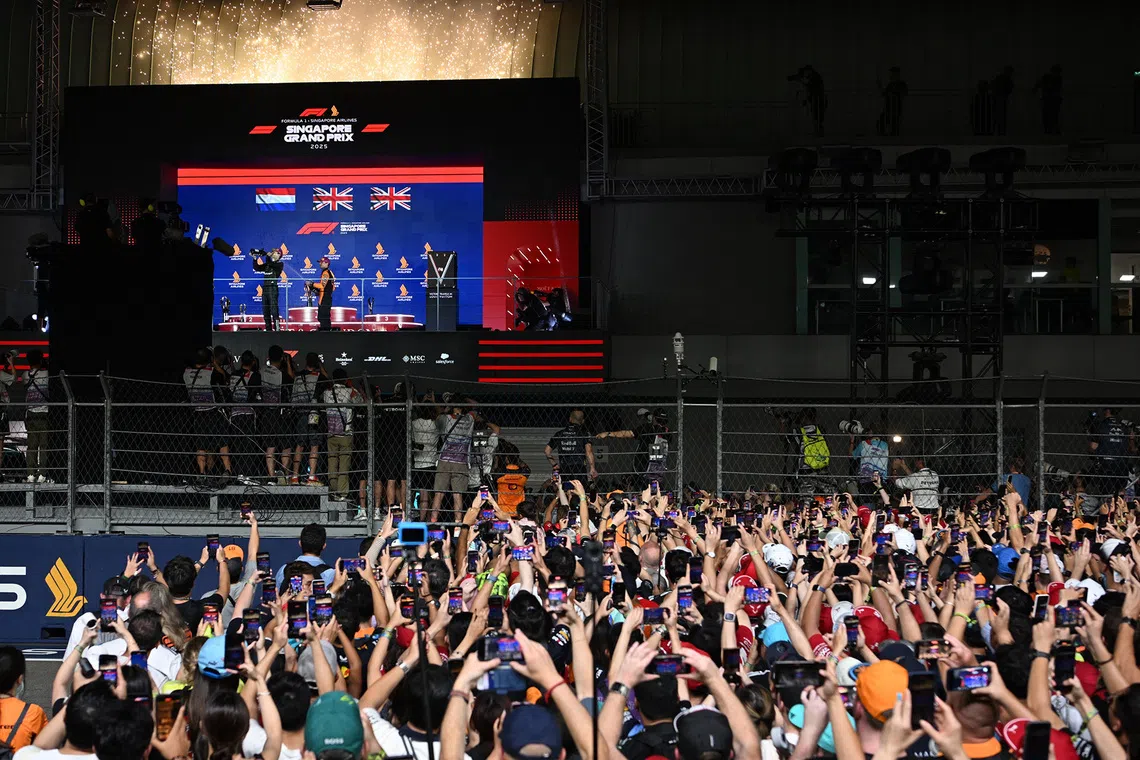 Crowd reacts to Mercedes' George Russell's victory at the 2025 Formula One Singapore Airlines Singapore Grand Prix at the Marina Bay Street Circuit on Oct 5, 2025. 