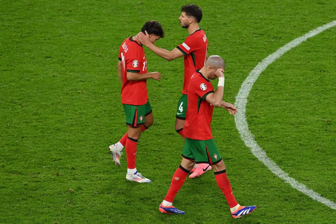 Soccer Football - Euro 2024 - Quarter Final - Portugal v France - Hamburg Volksparkstadion, Hamburg, Germany - July 5, 2024 Portugal's Joao Felix is consoled by Ruben Dias after missing a penalty in the penalty shootout REUTERS/Annegret Hilse