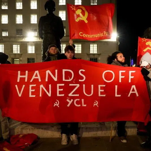 Campaigners hold banners and flags protesting against the US actions in Venezuela outside Downing Street in London, Britain, on Jan 5.