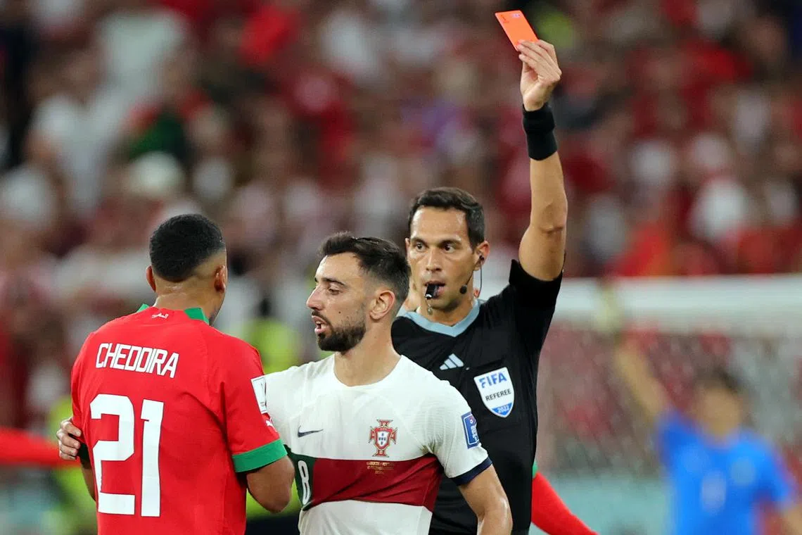 Argentine referee Facundo Tello shows the red card to Walid Cheddira of Morocco, during the  quarter final match against Portugal.
