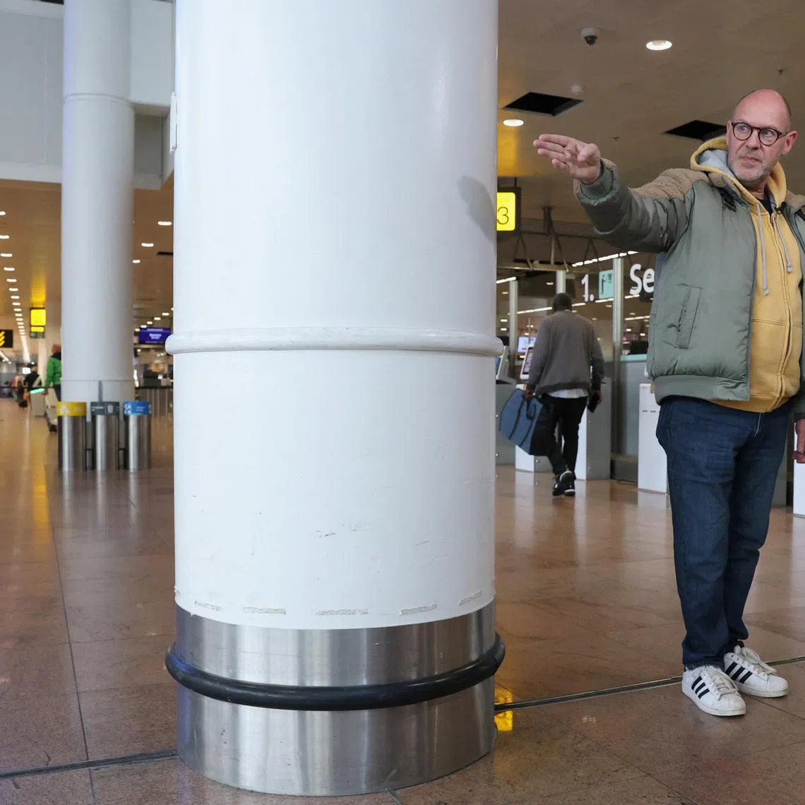 Belgian Walter Benjamin, who lost a leg in the March 22, 2016 suicide bomb attack at Brussels Airport, talks to Reuters while standing where he was during the blast as the Belgium prepares to mark the 10th anniversary of the attack, at Brussels Airport in Zaventem, Belgium, March 10, 2026. REUTERS/Yves Herman