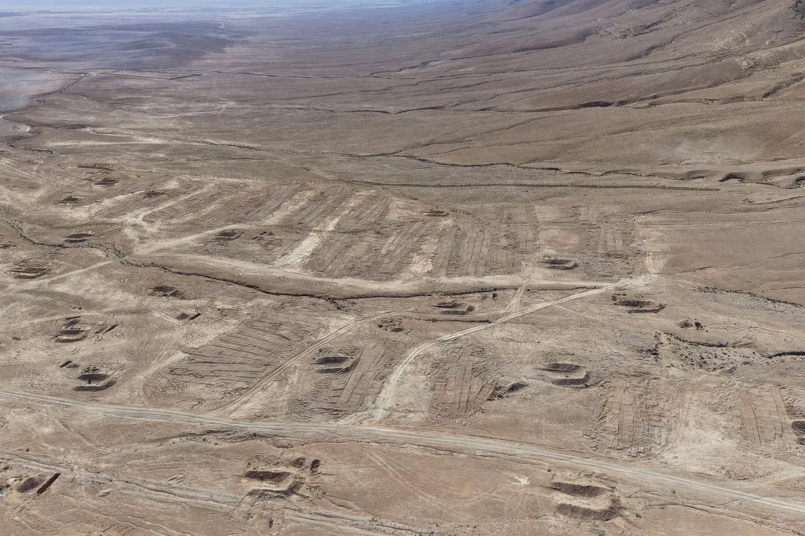 A drone view of the mass grave site in the desert near the eastern Syrian town of Dhumair, February 27, 2025.  REUTERS/Khalil Ashawi