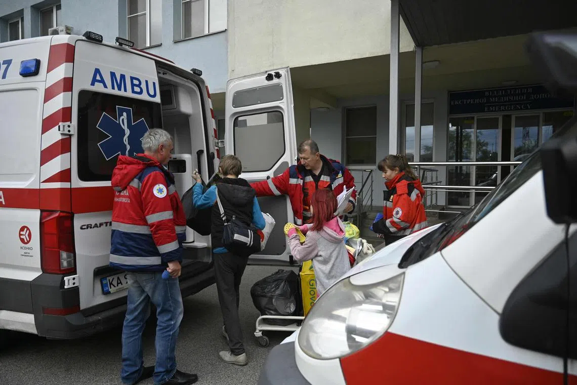 Medical workers loading children and equipment into an ambulance during the evacuation of a children's hospital in Kyiv, on April 26, 2024.