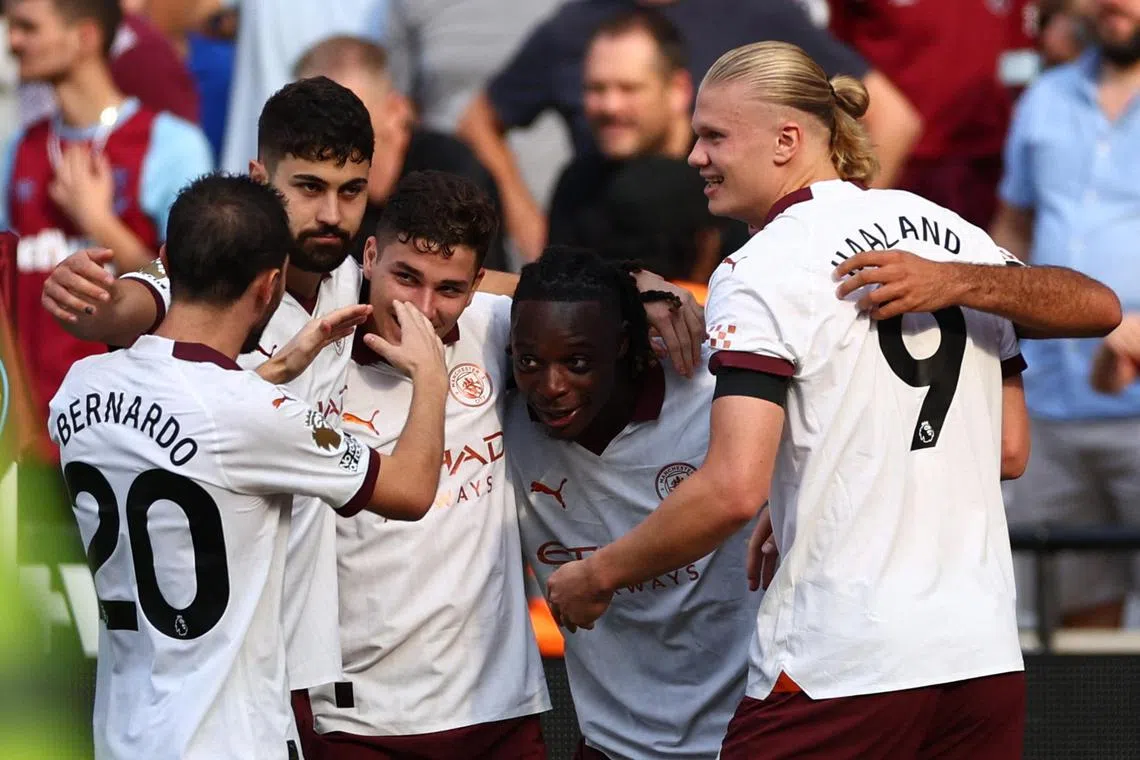 Manchester City's Jeremy Doku celebrates scoring their first goal with Bernardo Silva, Josko Gvardiol, Julian Alvarez and Erling Haaland.