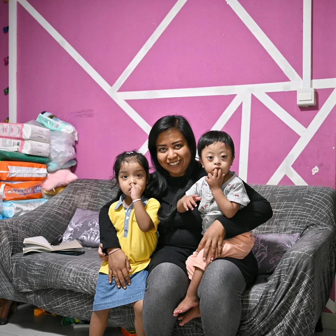 ComLink+ beneficiary Maznah Senen with two of her five children – three-year-old twins Nur Saida Sufian (left) and Mohammad Safiy Sufian.