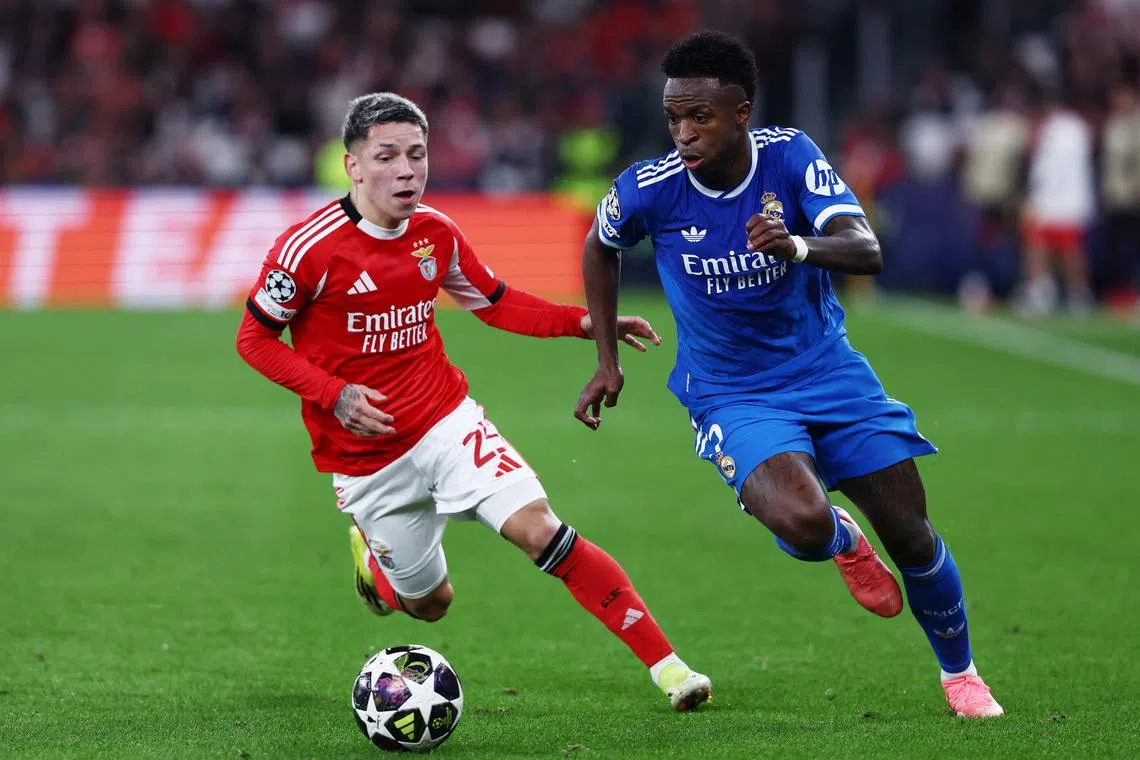 Soccer Football - UEFA Champions League - Play Off - First Leg - Benfica v Real Madrid - Estadio da Luz, Lisbon, Portugal - February 17, 2026 Benfica's Gianluca Prestianni in action with Real Madrid's Vinicius Junior REUTERS/Rodrigo Antunes