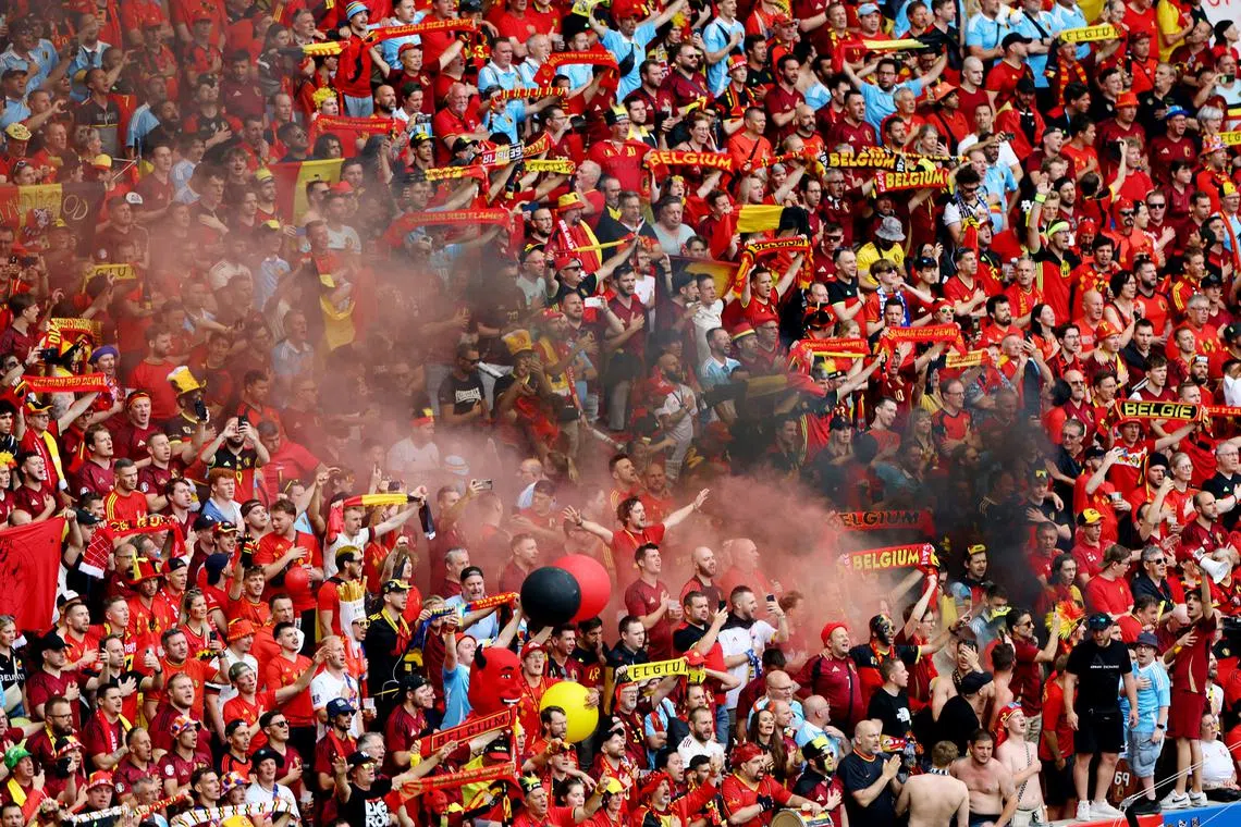 Soccer Football - Euro 2024 - Group E - Ukraine v Belgium - Stuttgart Arena, Stuttgart, Germany - June 26, 2024 Belgium fans set off smoke bombs inside the stadium before the match REUTERS/Leonhard Simon