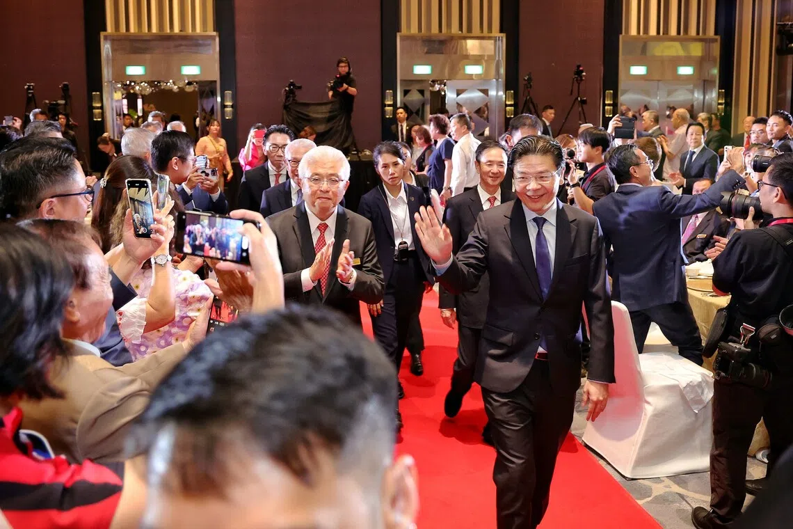 PM Lawrence Wong, accompanied by Singapore Federation of Chinese Clan Associations (SFCCA) president Thomas Chua, arriving at SFCCA’s 40th anniversary gala dinner on Oct 13.