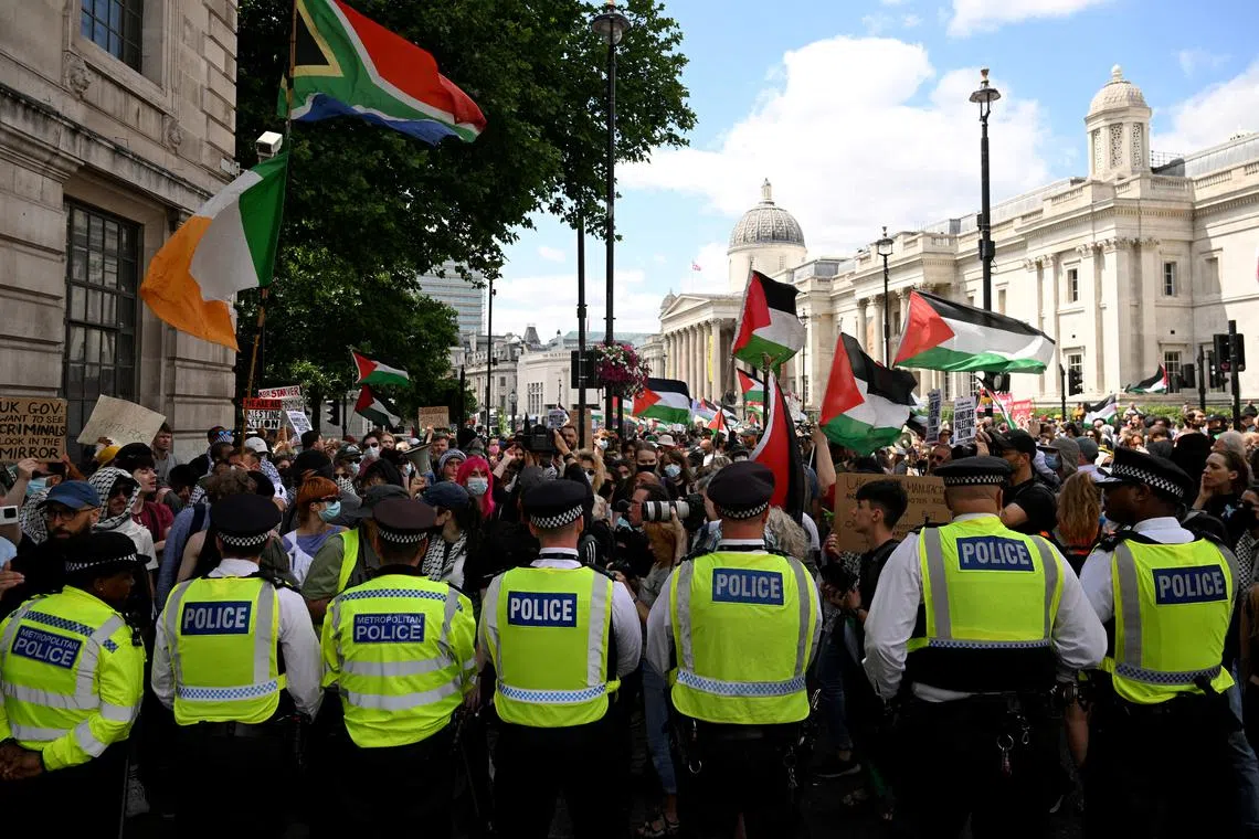 FILE PHOTO: Police officers block a street as pro-Palestinian demonstrators gather in protest against Britain's Home Secretary Yvette Cooper's plans to proscribe the \"Palestine Action\" group in the coming weeks, in London, Britain, June 23, 2025. REUTERS/Jaimi Joy/File Photo