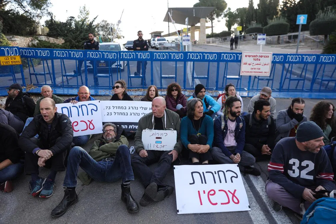 Israeli protestors hold up a placard reading "Elections now" during a demonstration against PM Benjamin Netanyahu's government, on Jan 8.