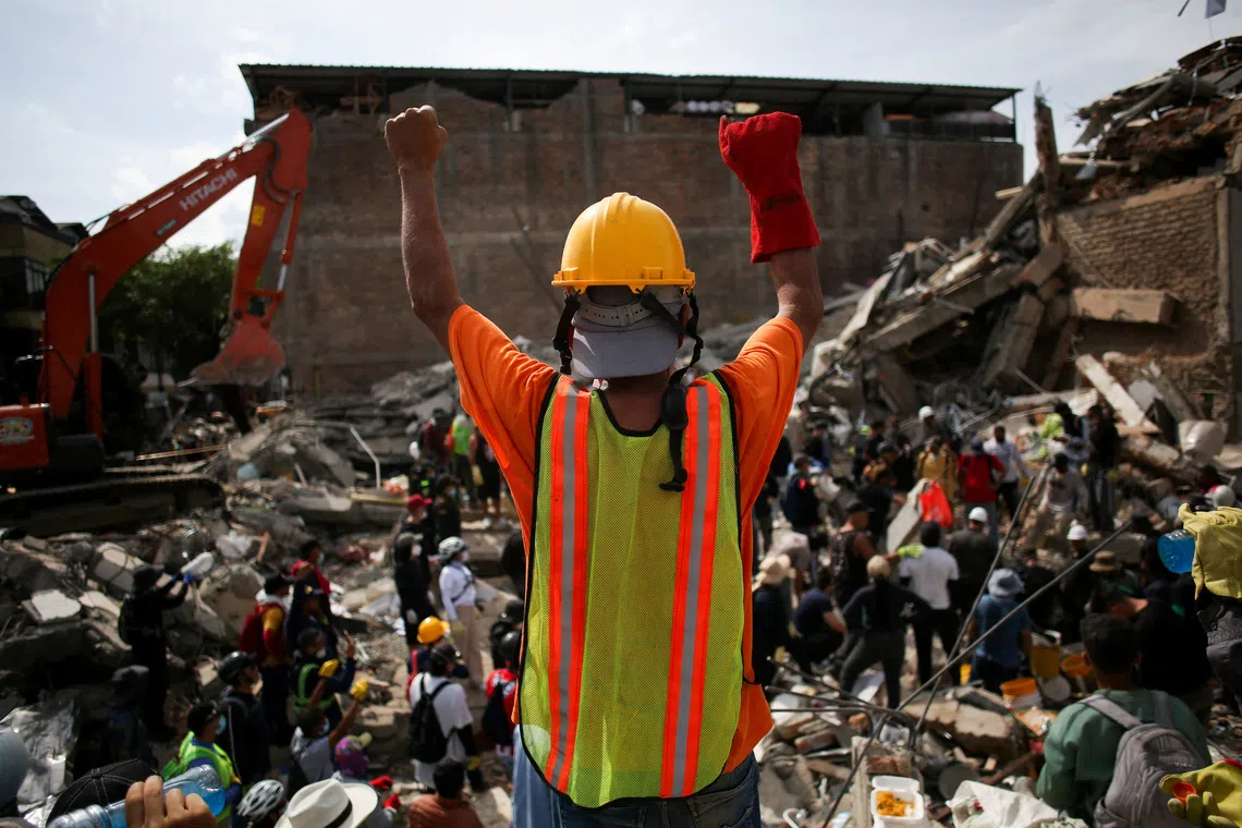 Volunteer rescuer Julio Cesar Pineda, 65, at the site of a building damaged in an earthquake, in Pereira, Colombia.