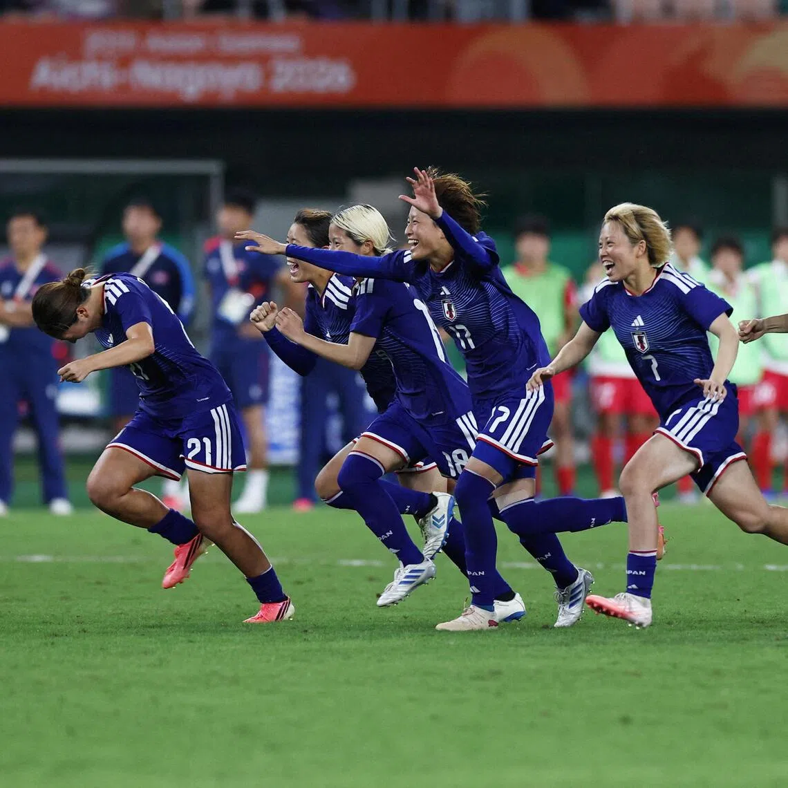 Japan’s women’s team players celebrate after winning the penalty shoot-out against North Korea at Shizuoka Stadium Ecopa in Fukuroi on Oct 2.