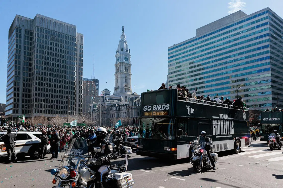 The Philadelphia Eagles celebrate on buses during the Super Bowl LIX championship parade.