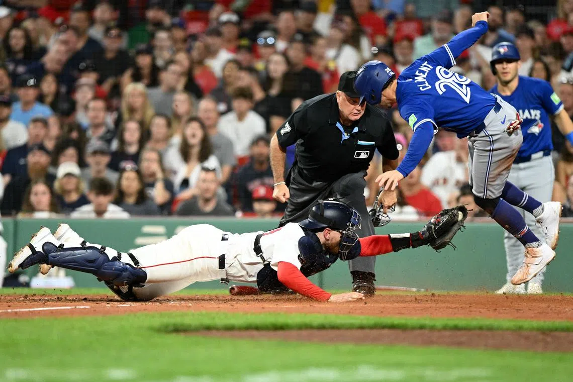 Aug 27, 2024; Boston, Massachusetts, USA; Boston Red Sox catcher Danny Jansen (28) tags out Toronto Blue Jays third baseman Ernie Clement (28) at home during the fourth inning at Fenway Park. Brian Fluharty-USA TODAY Sports/File Photo