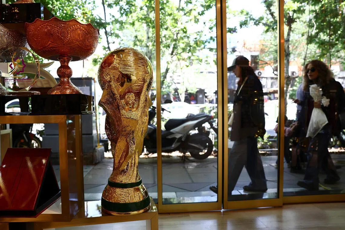 A replica of the FIFA World Cup trophy is displayed in a shop, in Tehran, Iran.