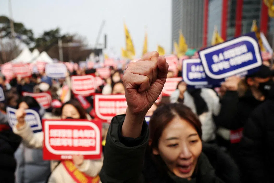 South Korean doctors chant slogans during a rally on March 3 to protest against government plans to increase medical school admissions in Seoul, South Korea.