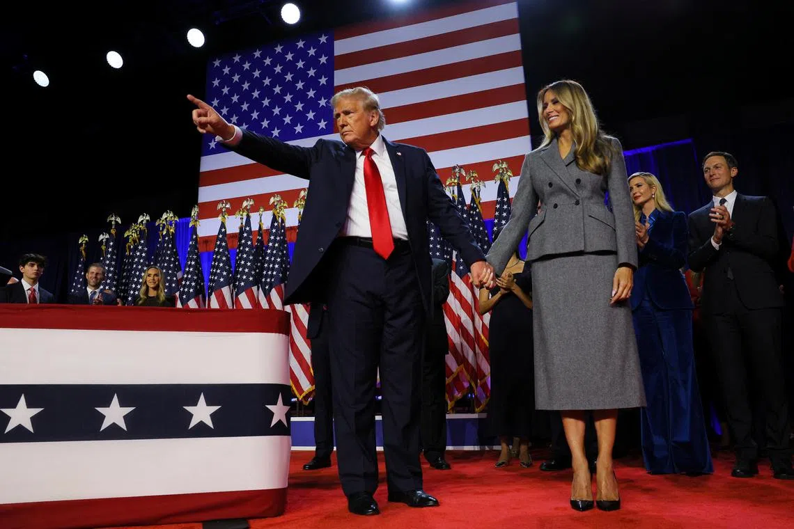 FILE PHOTO: Republican presidential nominee former U.S. President Donald Trump gestures next to his wife Melania Trump, following early results from the 2024 U.S. presidential election in Palm Beach County Convention Center, in West Palm Beach, Florida, U.S., November 6, 2024.  REUTERS/Brian Snyder/File Photo