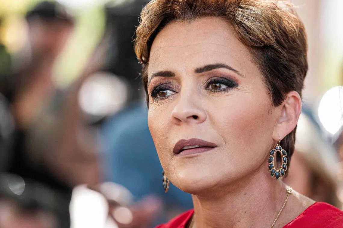 (FILES) In this file photo taken on November 8, 2022 Republican gubernatorial candidate for Arizona Kari Lake speaks to members of the media after voting in the US midterm election, in Phoenix, Arizona. - Kari Lake, the Republican candidate for governor in the southwest US state of Arizona who had cast doubt on the 2020 election results, was projected by US media Monday to have lost. Lake's defeat by Democrat Katie Hobbs, projected by CNN and NBC, adds to the list of candidates supported by former president Donald Trump who had made skepticism of his 2020 election loss to Joe Biden a major plank of their campaigns. (Photo by Olivier Touron / AFP)