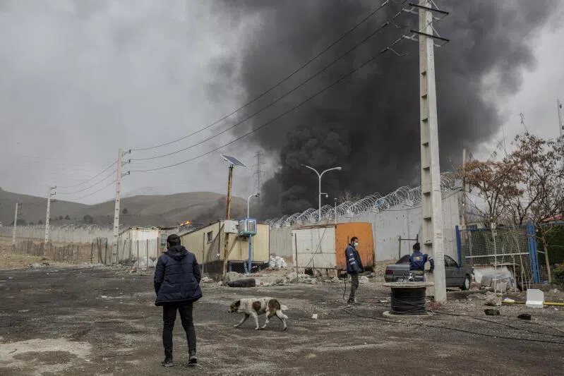 Plumes of smoke rise from an oil storage facility after overnight strikes by US and Israeli forces in Tehran, Iran, on March 8, 2026.