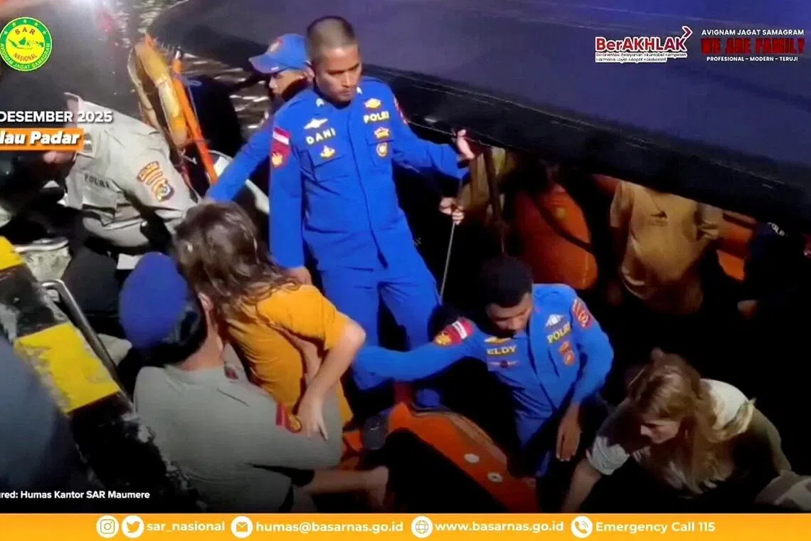 Rescue teams help to depart the rescued, as Indonesia's National Search and Rescue Agency (BASARNAS) said, after a boat carrying several people sank off the coast of Indonesia in extreme weather, Spanish authorities and an Indonesian news agency said, in Indonesia, in this screengrab from the video obtained by Reuters on December 27, 2025. A Spanish family, father and three of his children, have been missing since Friday night when the boat capsized in waves of up to three meters in the Padar Island Strait. Indonesia's National Search and Rescue Agency (BASARNAS)/Handout via REUTERS THIS IMAGE HAS BEEN SUPPLIED BY A THIRD PARTY. MANDATORY CREDIT. OVERLAYS FROM SOURCE.