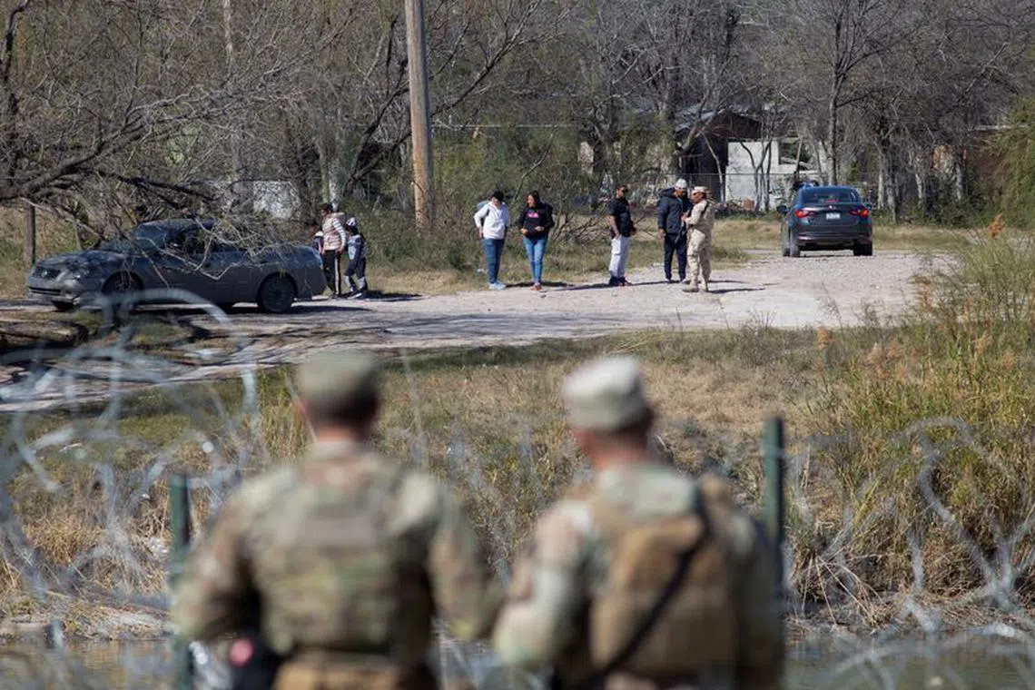 FILE PHOTO: Texas National Guard troops watch a Mexican official prevent a group of people from entering the Rio Grande River across from Shelby Park at the U.S.-Mexico border in Eagle Pass, Texas, U.S., January 12, 2024.     REUTERS/Kaylee Greenlee Beal/File Photo