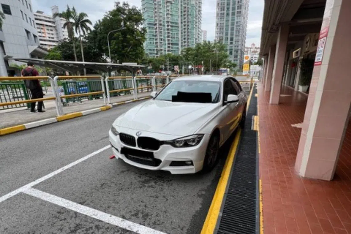 Ms Elaine Ong's car was fitted with a wheel clamp for parking illegally at the Chiap Chuan Building, with her being told that she had mounted the kerb.
