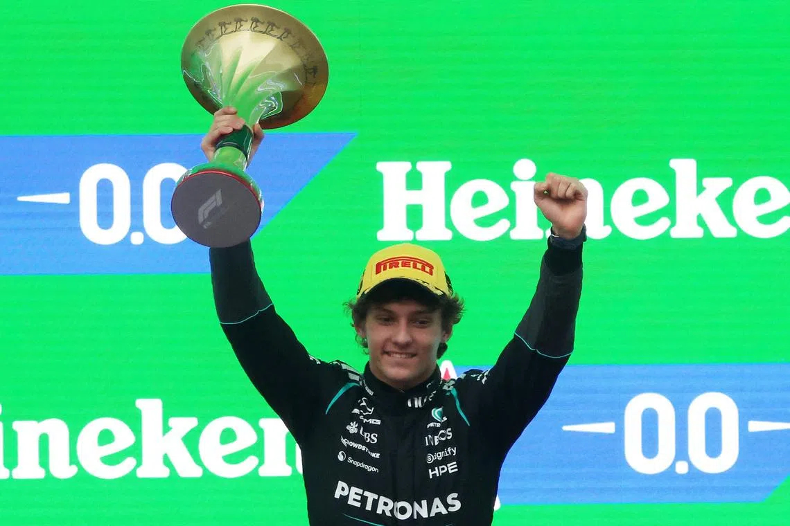 Formula One F1 - Chinese Grand Prix - Shanghai International Circuit, Shanghai, China - March 15, 2026 Mercedes' Andrea Kimi Antonelli celebrates with a trophy on the podium after winning the Chinese Grand Prix REUTERS/Maxim Shemetov
