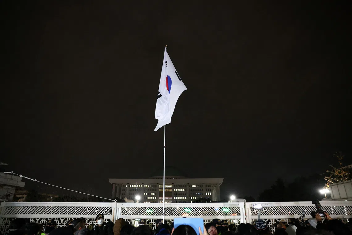 South Korean flag hangs on a pole outside the gate of the National Assembly, on Dec 4, 2024.