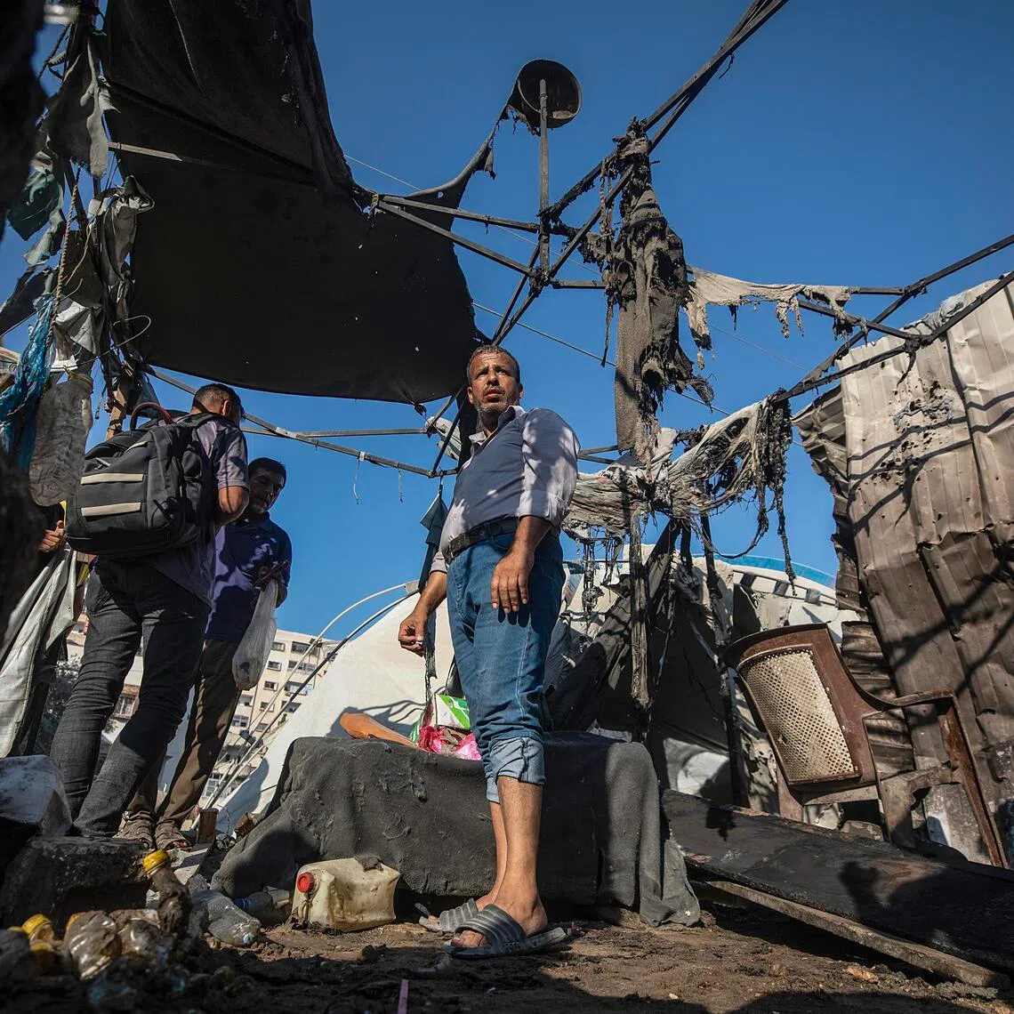 Palestinians inspecting the damage following an Israeli airstrike in Gaza City on Aug 27.