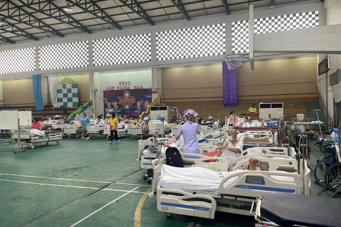 Patients at a makeshift medical treatment area in the recreational hall of a hospital in Bangkok on March 29.