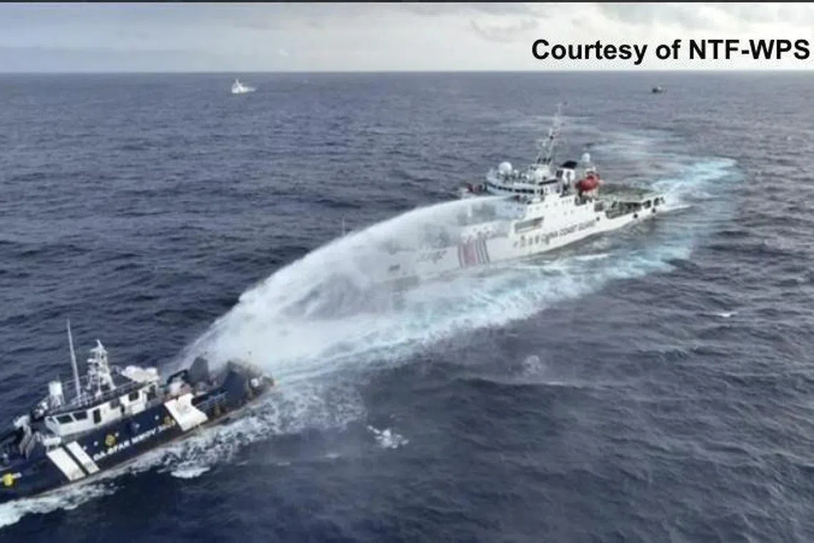 A Chinese coast guard vessel is seen firing a water cannon at a Philippine resupply boat near Scarborough Shoal.