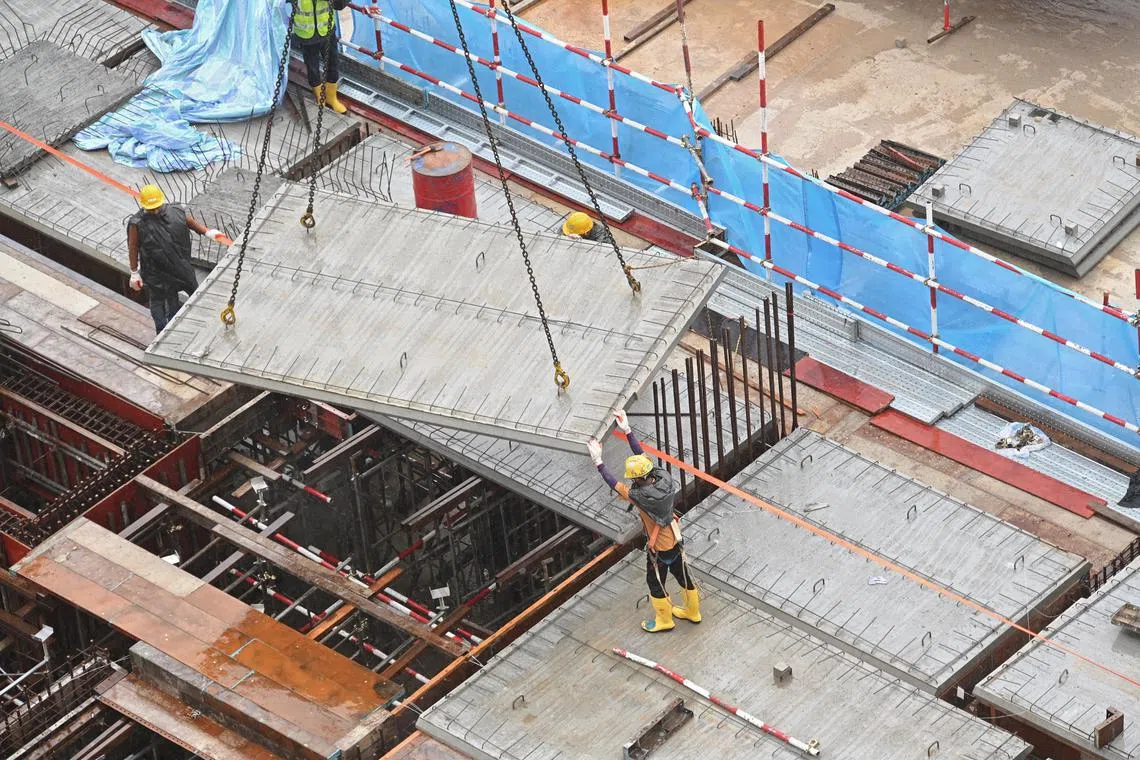 Pixgeneric /pixrain /generic picture of construction workers donning rain ponchos while working under rainy condition in HDB ‘ Dakota One’ BTO construction site near Jalan Dua and Cassia Link on 25 Jan 2023 .