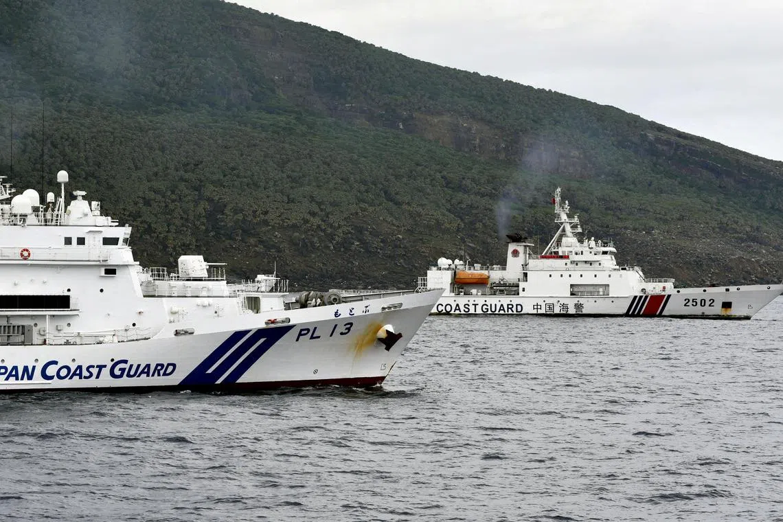 FILE PHOTO: A China Coast Guard vessel No.2502 sails near a Japan Coast Guard vessel Motobu off Uotsuri Island, one of a group of disputed islands called Senkaku Islands in Japan, also known in China as Diaoyu Islands, in the East China Sea April 27, 2024, in this photo released by Kyodo.  Mandatory credit Kyodo/via REUTERS/File Photo