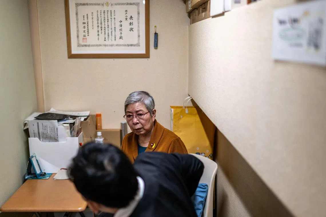 Retired unpaid parole officerTeruko Nakazawa speaking to her former parolee.