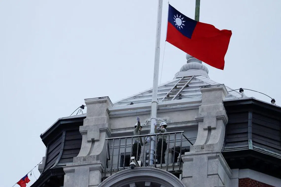 FILE PHOTO: Honor guards raise a Taiwanese flag at the Presidential Palace ahead of the National Day celebration ceremony in Taipei, Taiwan October 10, 2023. REUTERS/Carlos Garcia Rawlins/File Photo