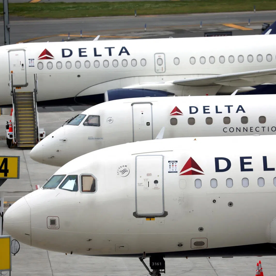 FILE PHOTO: Delta Airlines passenger jets are pictured outside the newly completed 1.3 million-square foot $4 billion Delta Airlines Terminal C at LaGuardia Airport in the Queens borough of New York City, New York, U.S., June 1, 2022. REUTERS/Mike Segar/File Photo