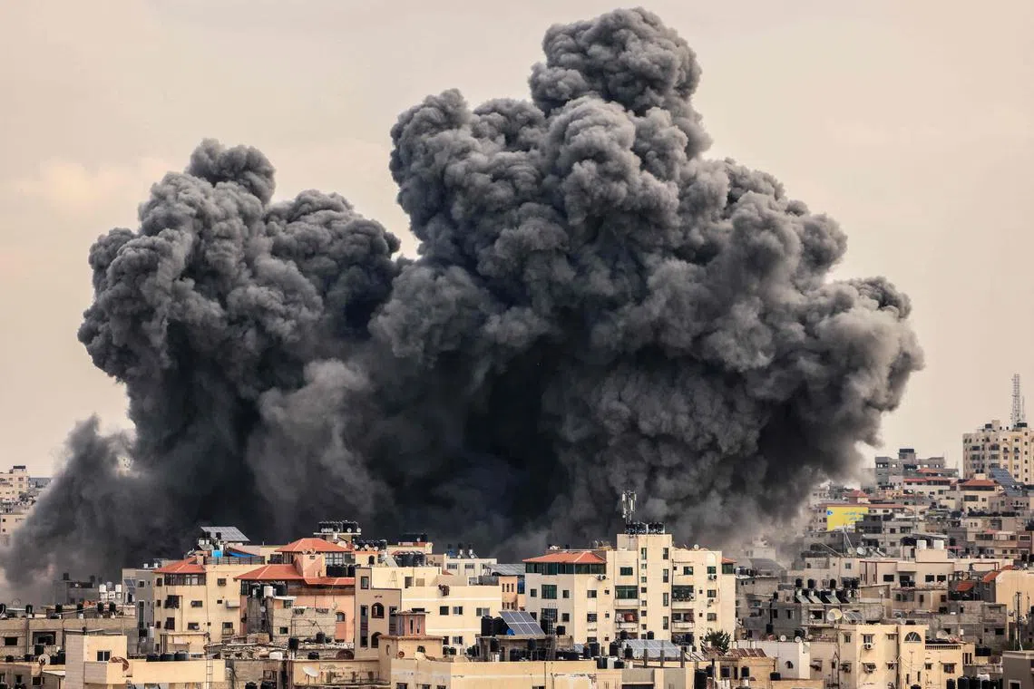 A plume of smoke rises in the sky of Gaza City during an Israeli airstrike on Oct 9.