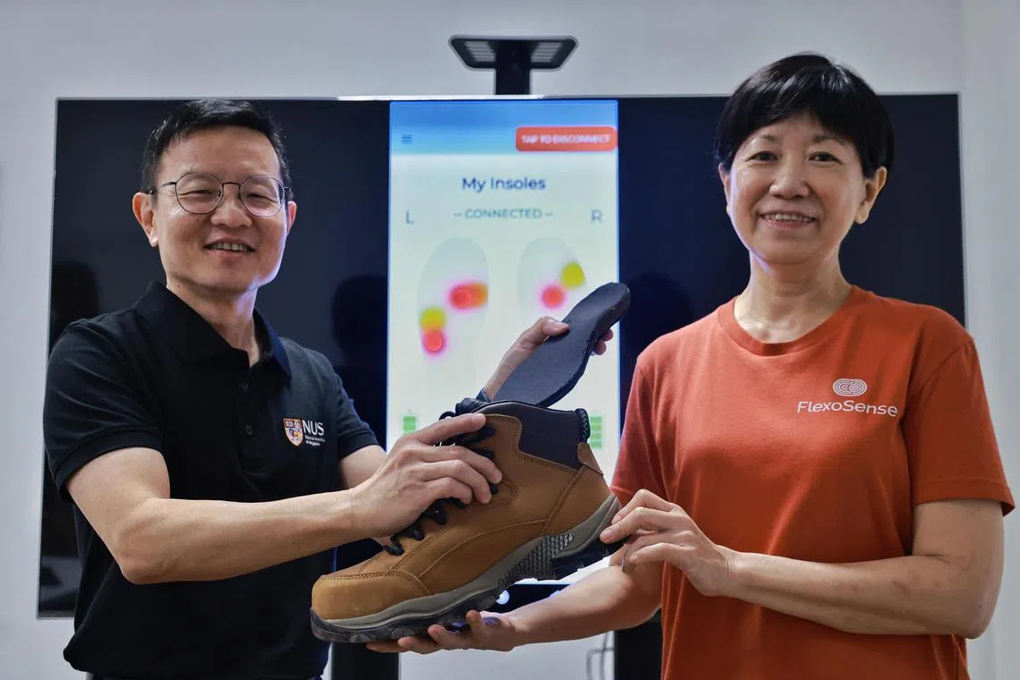 ST20230207_202381390954/jtinsole13/Josiah/Jason Quah Prof Lim Chwee Teck (L), director, iHealthtech, NUS and Ms Chia Lye Peng, CEO, FlexoSense, pose with their smart insole on Feb 7, 2023. // Harnessing the power of research and technology to boost workplace safety, Professor Lim Chwee Teck from the NUS Institute for Health Innovation & Technology (iHealthtech) collaborated with NUS start-up, FlexoSense, to develop a smart insole which can track workplace STFs in real time and is the first of its kind that can detect a person's balance. The insole will allow companies to identify the location of an incident and highlight STF risk areas in order to implement suitable mitigation measures.