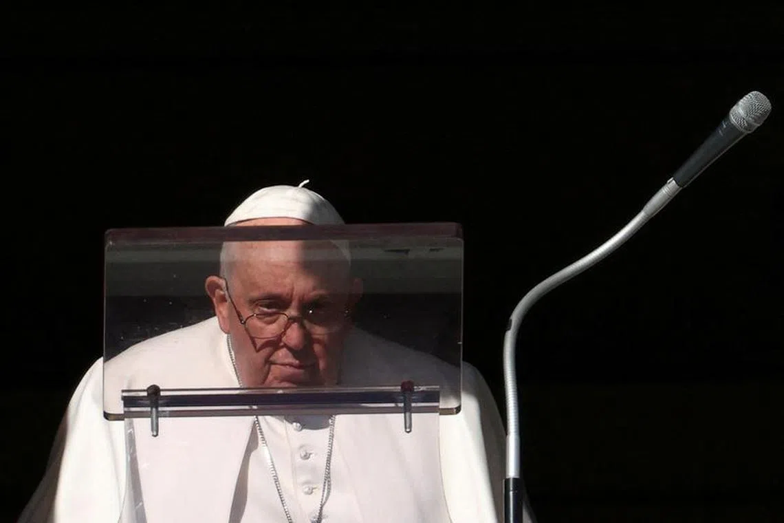 Pope Francis looks on to lead the Angelus prayer from his window, at the Vatican, December 17, 2023. REUTERS/Guglielmo Mangiapane