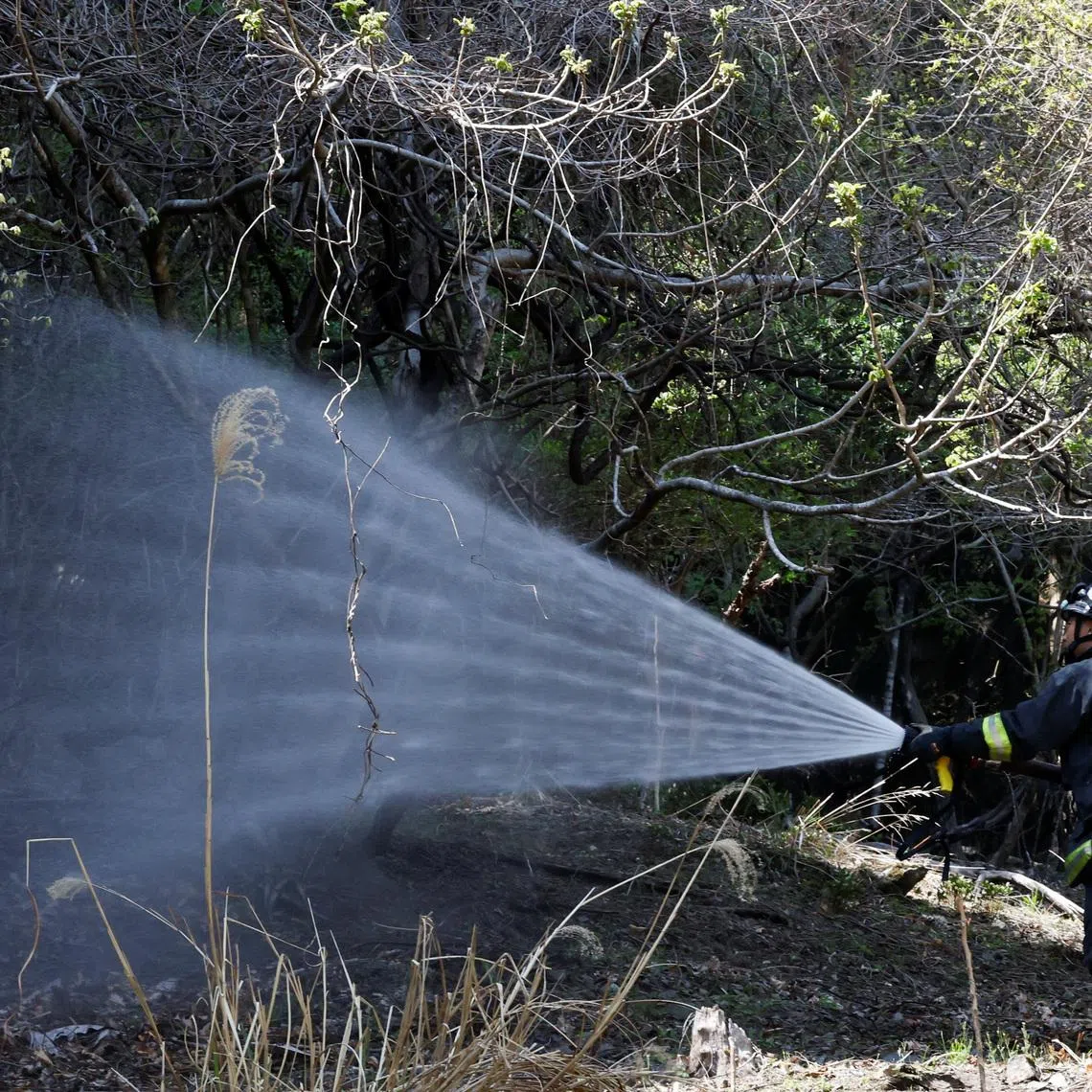 A firefighter works as wildfires continue in Otsuchi, Iwate Prefecture, Japan on April 26.