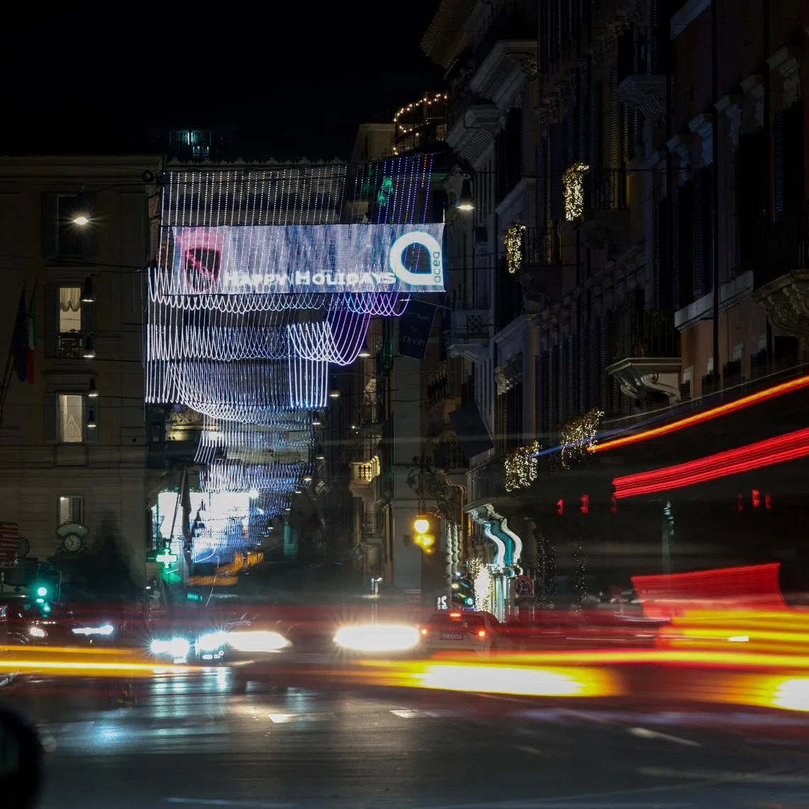 Cars drive in a street adorned with Christmas lights in Rome, Italy December 12, 2025. Picture taken with a slow shutter speed. REUTERS/Francesco Fotia