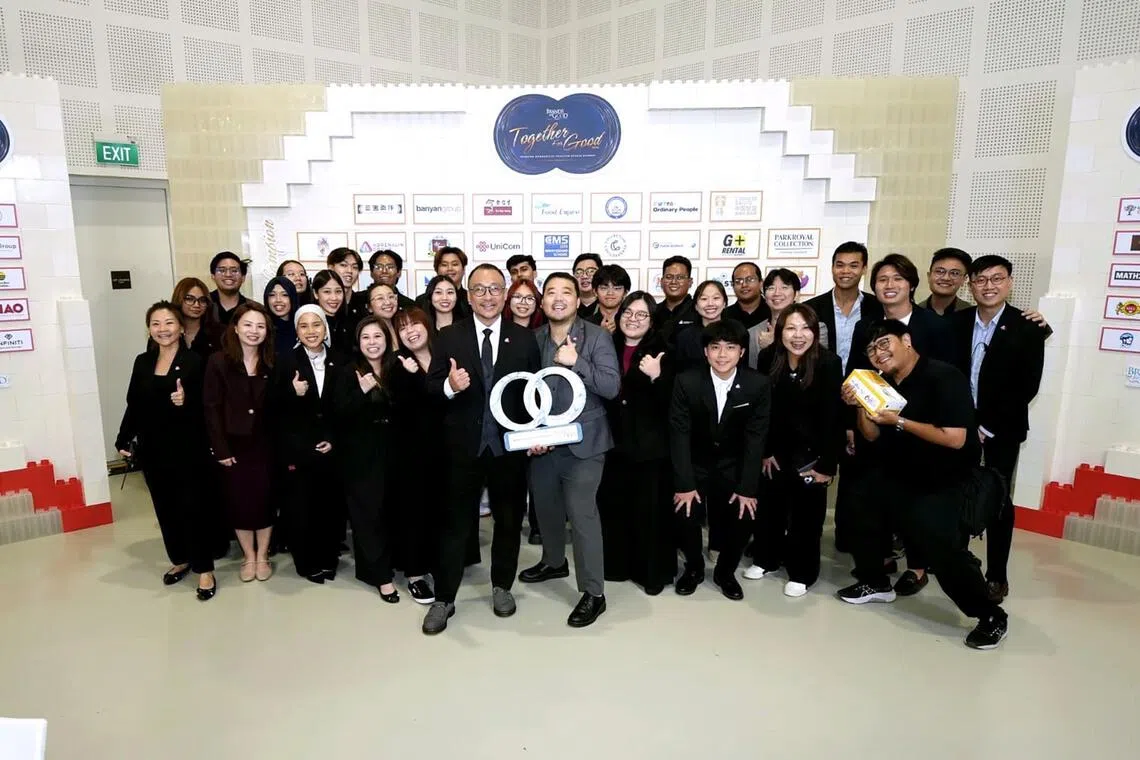 Group managing director of Adrenalin Group Jeremy Tan (in suit and tie) runs an events management and production company where 30 per cent of its 30 staff are parents.