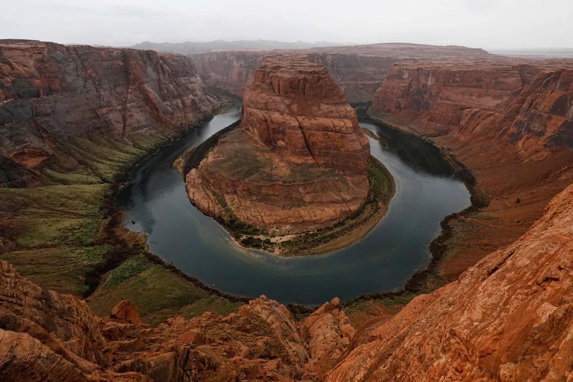 (FILES) The Colorado River wraps around Horseshoe Bend in the in Glen Canyon National Recreation Area in Page, Arizona, on February 11, 2017. Western US states said May 22, 2023 they have reached an agreement to cut the amount of water they take from the dwindling Colorado River, which is threatened by a quarter of a century of drought and worsening climate conditions. (Photo by RHONA WISE / AFP)