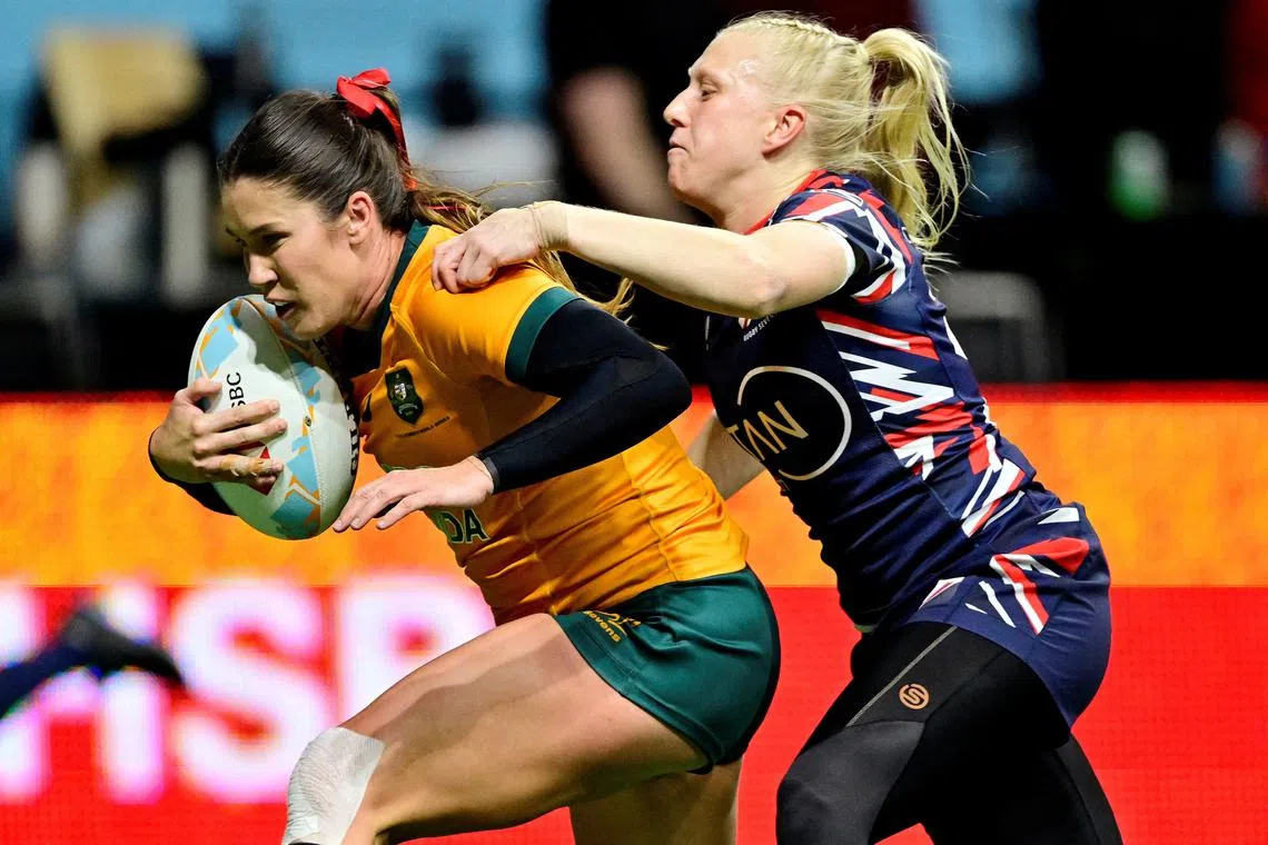 FILE PHOTO: Rugby Union - HSBC Sevens - Australia v Britain - Cup Quarter Final - Vancouver - BC Place, Vancouver, Canada - February 22, 2025 Australia's Charlotte Caslick in action with Britain's Heather Cowell REUTERS/Jennifer Gauthier/File Photo