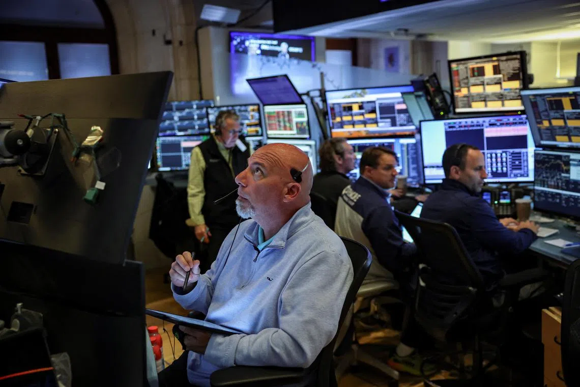 Traders work on the floor of the New York Stock Exchange, in New York City.